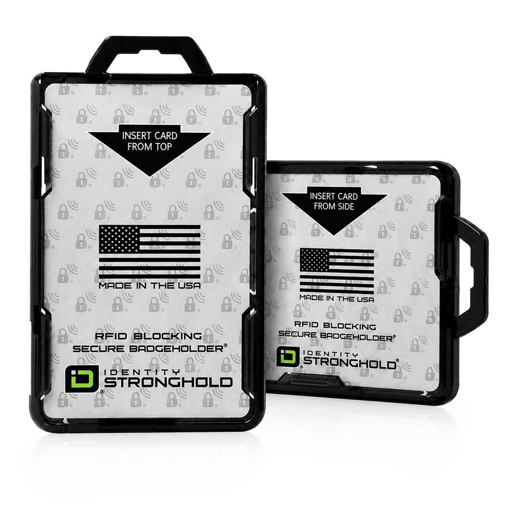 Two black plastic ID badge holder cases shown on a white background, one standing upright and one leaning against it. Both cases have a transparent front panel with printed text and an American flag graphic, plus the visible brand name Identity Stronghold.