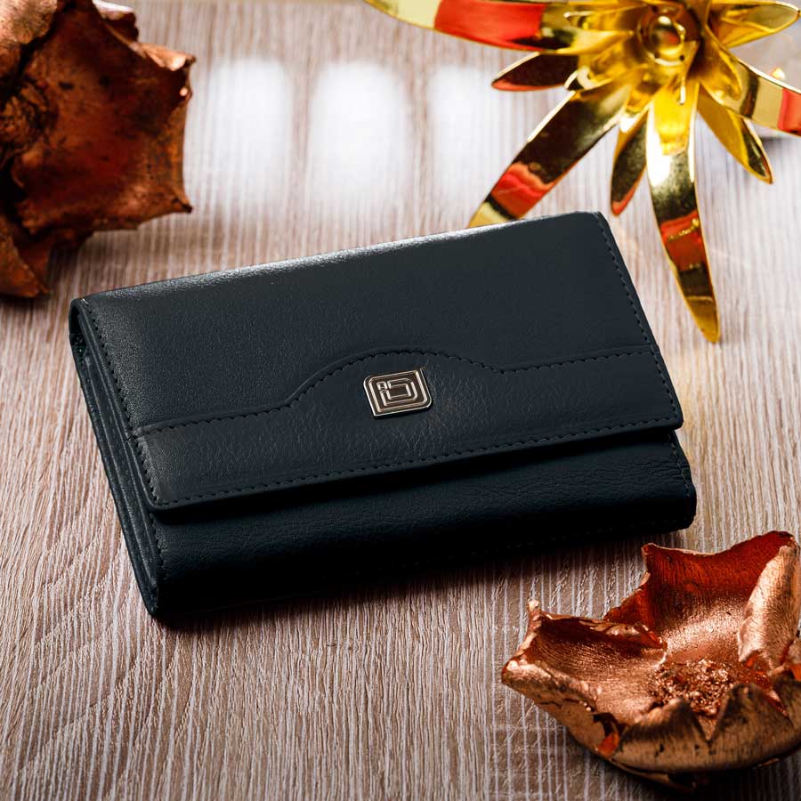 Black wallet on a wooden surface with decorative elements